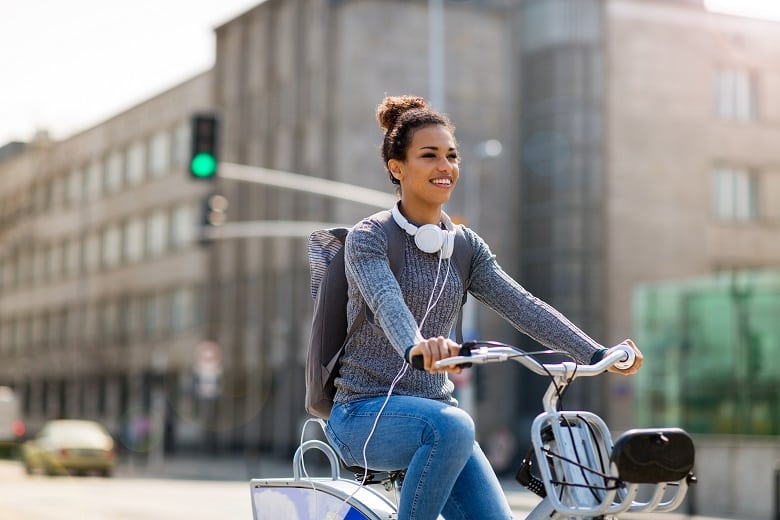 Young lady riding bike in a city