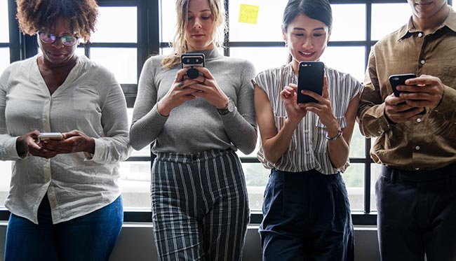 Adults on their cell phones in a casual setting